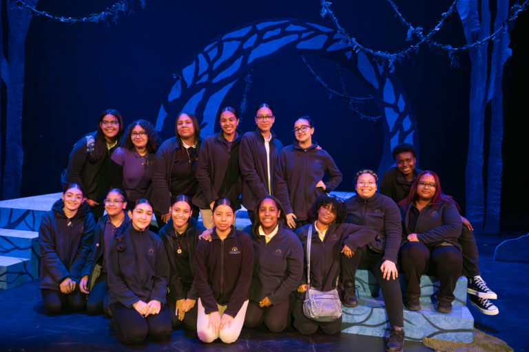 A group of Esperanza Academy students on stage at the Strand Theater