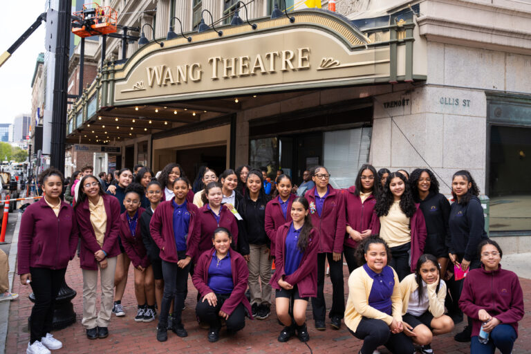 Students stand under the Wang Theatre marquee in Boston.